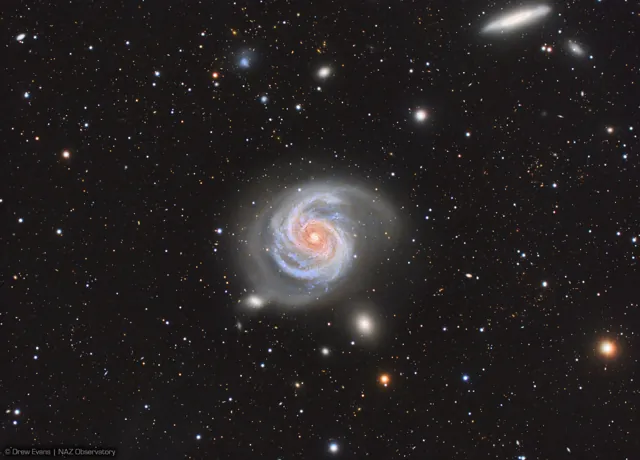 Spiral galaxy M100 with blue star clusters and winding dust lanes